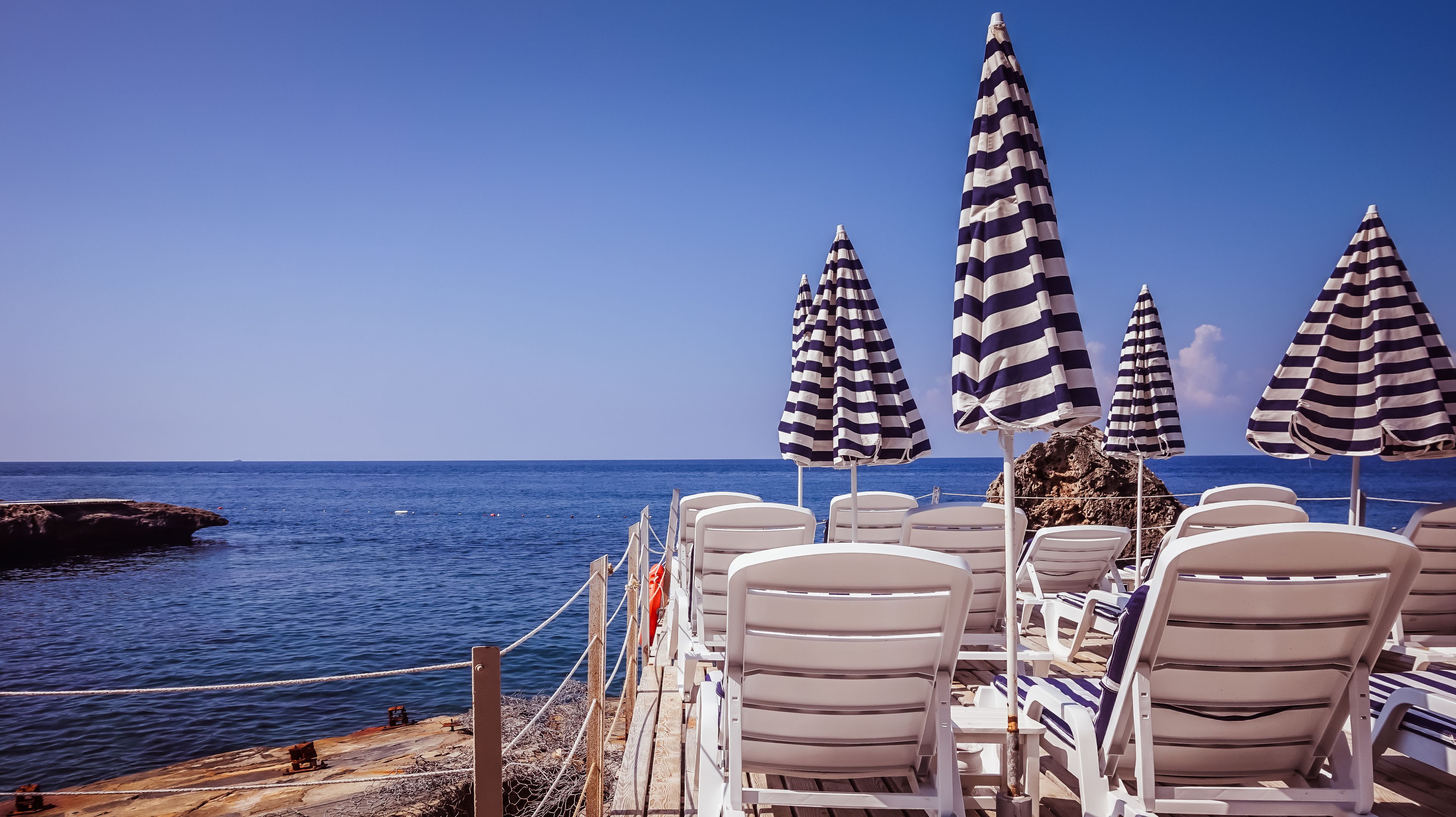 on the beach, sun-loungers, beach umbrellas, beach towels