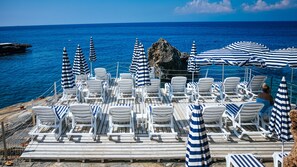 在海滩、沙滩椅、海滩遮阳伞、沙滩毛巾