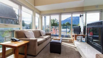 Studio + Loft (Unit 310) | Living area | 50-inch Smart TV with cable channels, fireplace