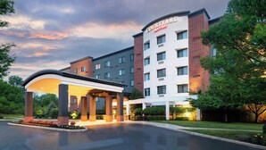 A Courtyard by Marriott hotel with a covered entrance, multiple floors, and a brick facade.