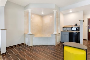 Suite, 1 King Bed, Non Smoking, Jetted Tub | Desk, laptop workspace, blackout drapes, iron/ironing board