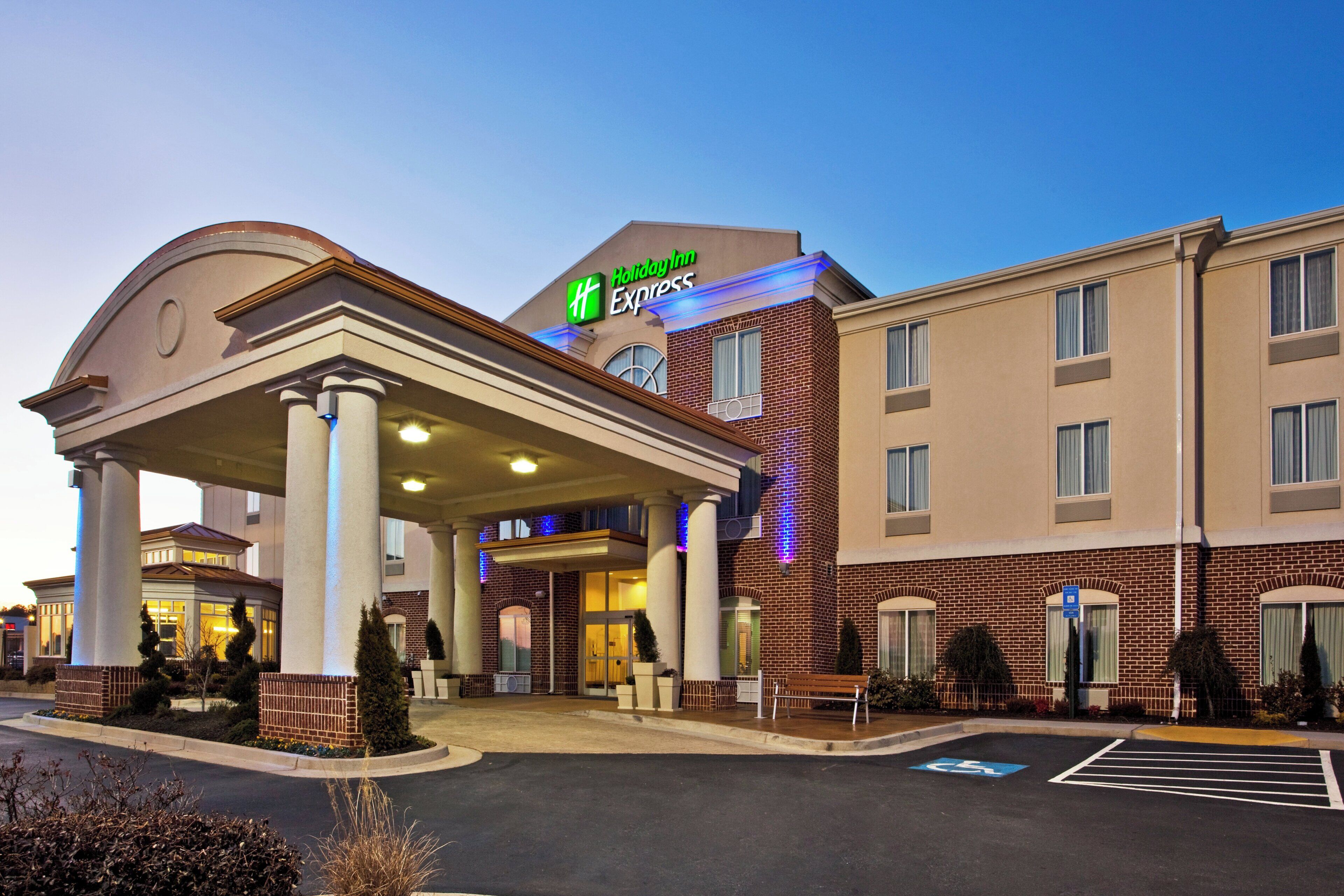 A Holiday Inn Express hotel with a covered entrance, multiple floors, and a parking lot.