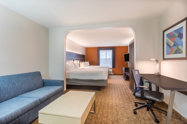 A hotel room with a bed, a desk, a chair, a sofa, and a small table. - Holiday Inn Express Hotel & Suites Bremen by IHG (Bremen)