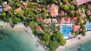 An aerial view of a resort with a beach, pool, and multiple buildings. - Renaissance Koh Samui Resort & Spa (Koh Samui)
