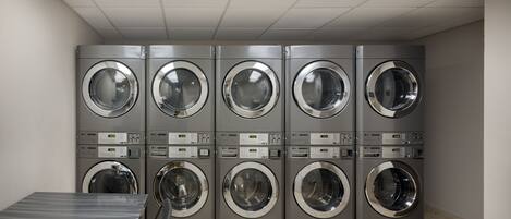 A laundry facility with multiple stacked washing machines.
