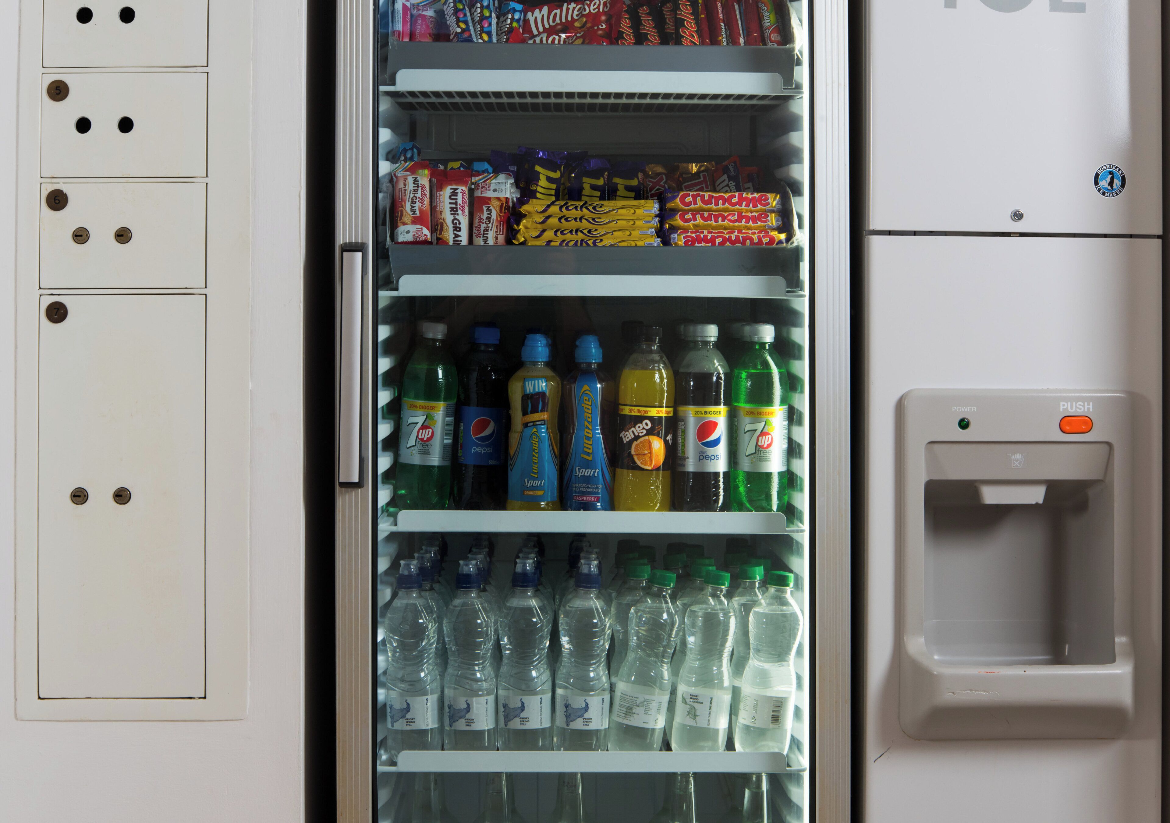 A vending machine stocked with snacks and beverages.