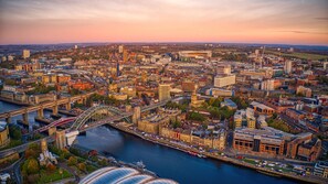 A cityscape with a prominent bridge, historic buildings, and a river. - Holiday Inn Express Newcastle City Centre by IHG (Newcastle-upon-Tyne)