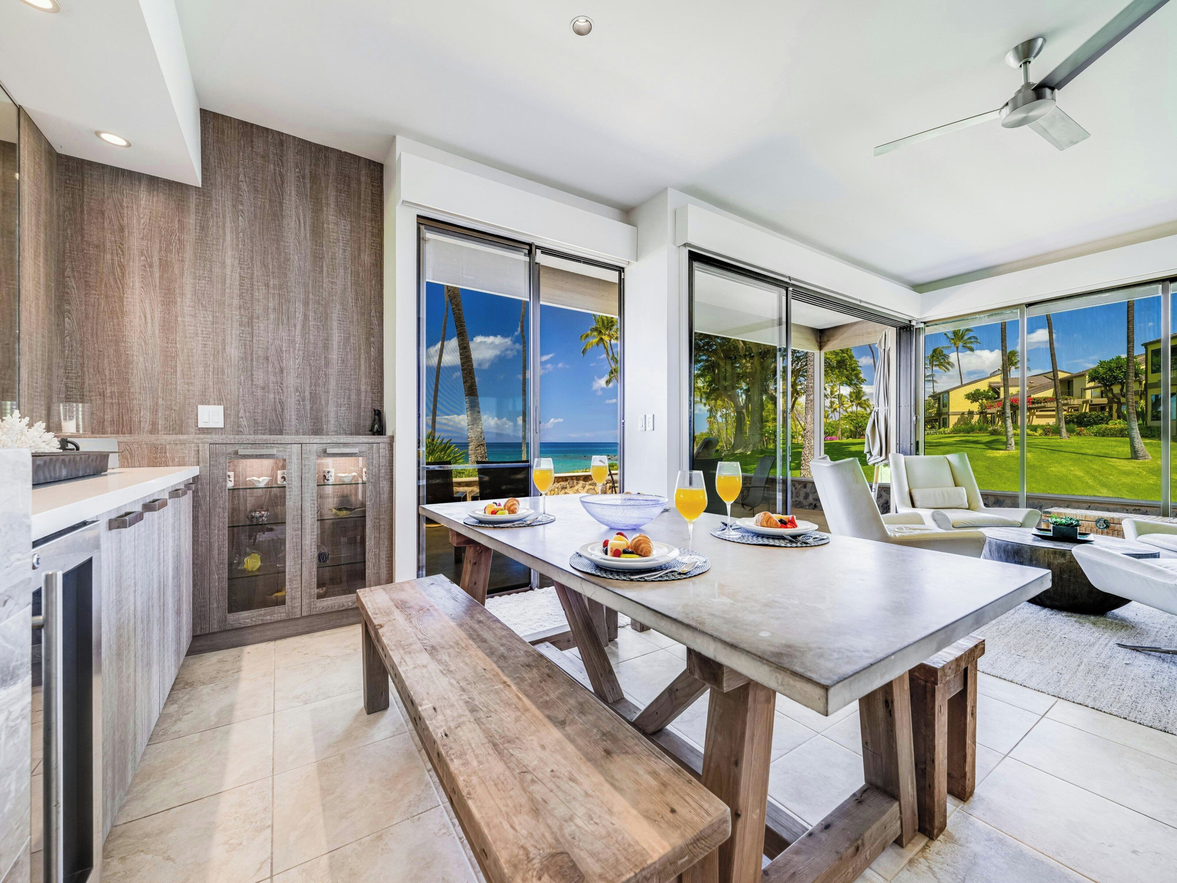 A modern kitchen with a dining area overlooking a scenic view.