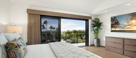 A modern bedroom with a large bed, a balcony with a view, a potted plant, and a painting on the wall.