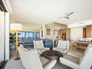 A modern living room with a sofa set, a coffee table, and a view of the ocean. - Wailea Elua- CoralTree Residence Collection (Kihei)