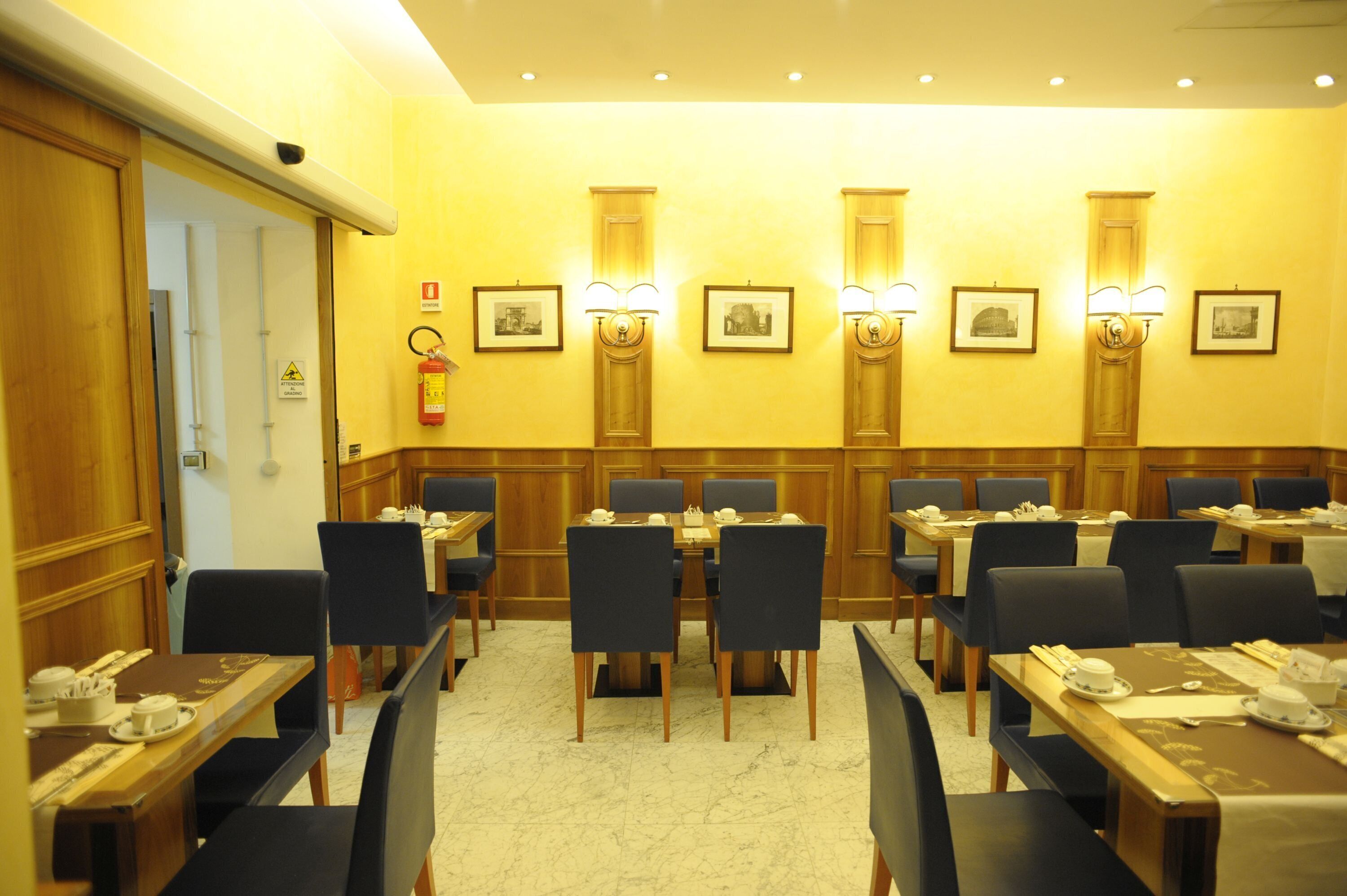 A conference room with multiple tables and chairs, equipped with nameplates and table settings.