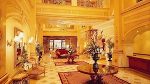 A grand lobby with ornate ceiling decorations, a chandelier, and a central fountain. - Peermont D'oreale Grande at Emperors Palace (Kempton Park)