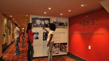 A hallway with a red wall and a poster titled "The Codesa Walk".
