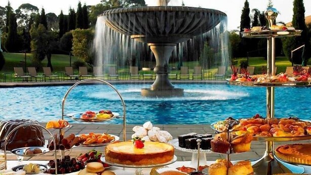 A buffet with various food items and a fountain in the background. - Peermont D'oreale Grande at Emperors Palace (Kempton Park)
