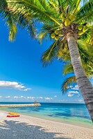 On the beach, white sand, sun loungers, beach towels