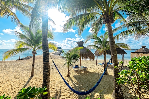 On the beach, white sand, sun loungers, beach towels