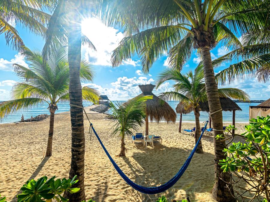On the beach, white sand, sun loungers, beach towels