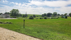 A grassy field with a building in the background. - Travelodge by Wyndham Hershey (Hershey)