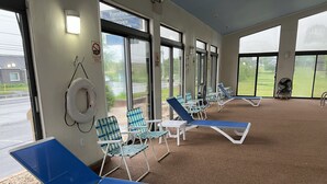 A poolside area with lounge chairs and a pool. - Travelodge by Wyndham Hershey (Hershey)