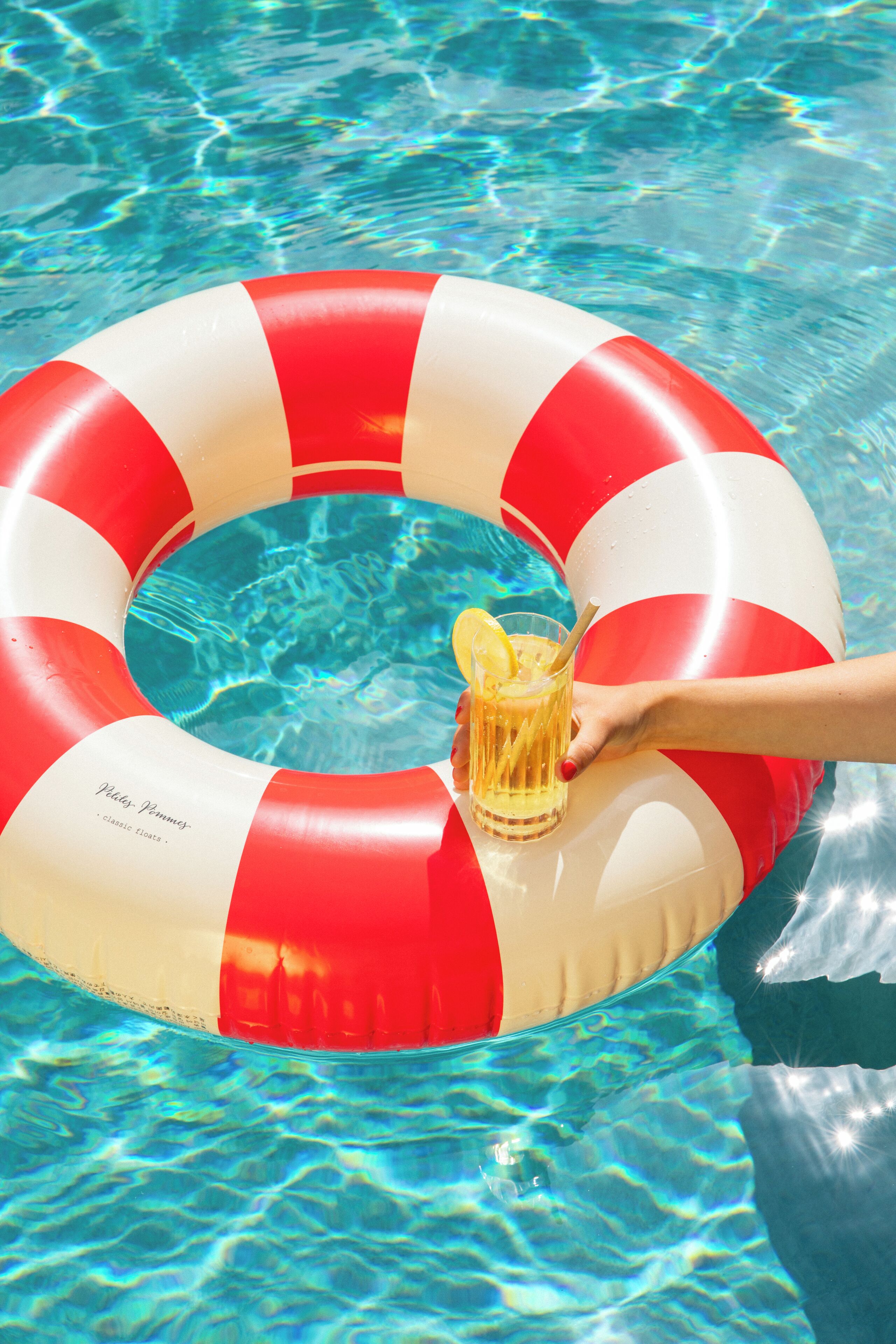A pool with a red and white inflatable ring.