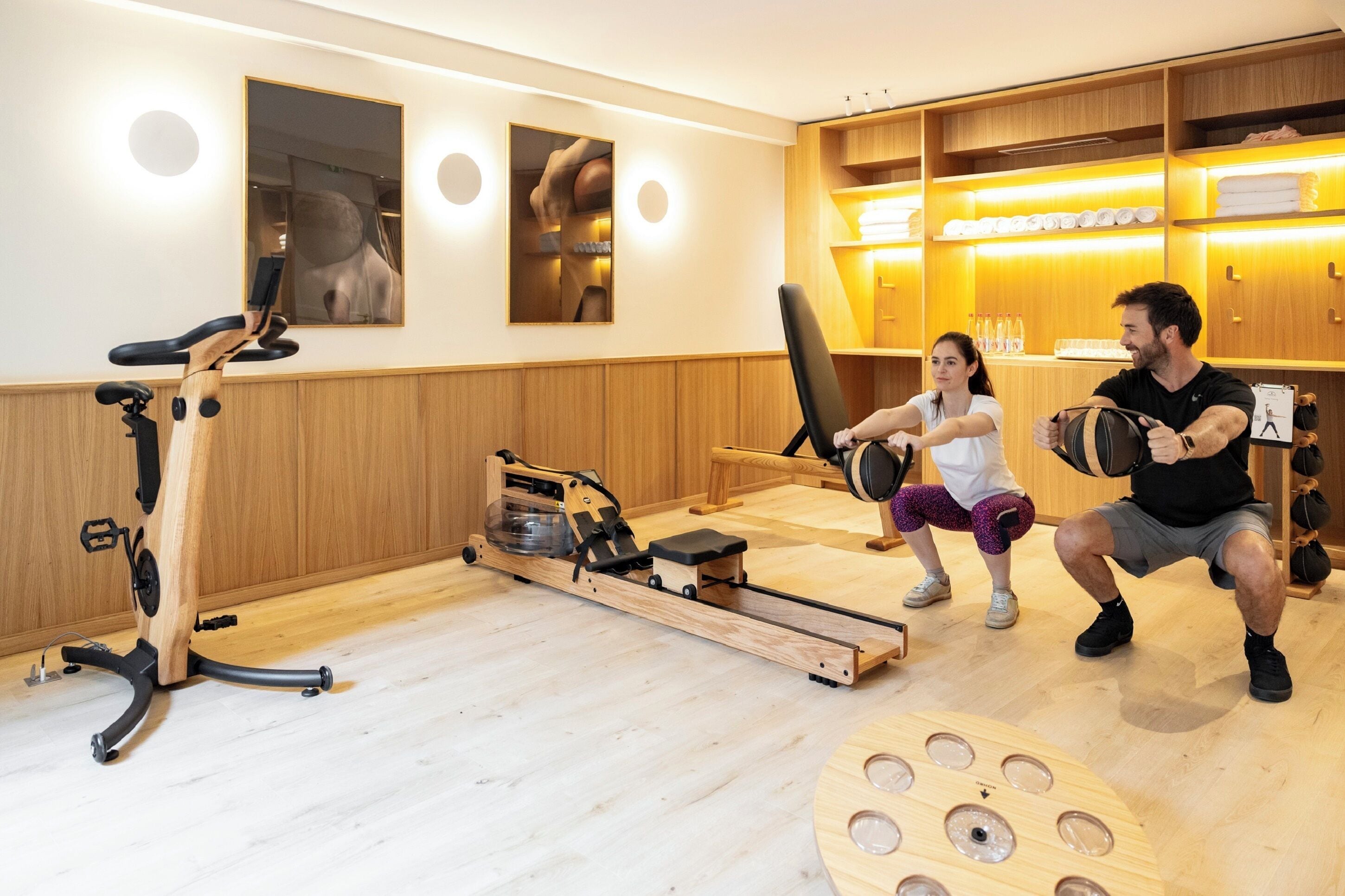 A home gym with exercise equipment, wooden walls, and a mirror.