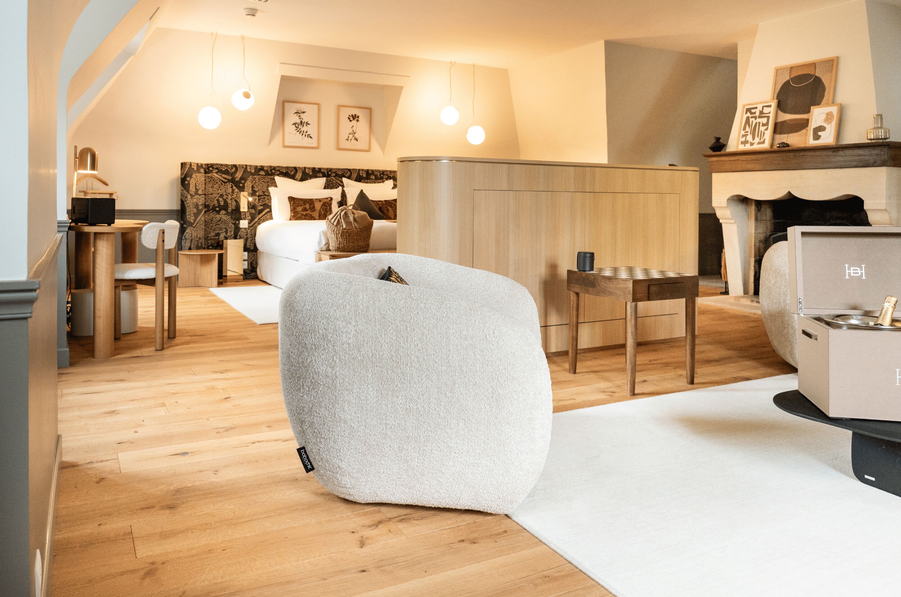 A modern living room with a sofa, a coffee table, and a fireplace.