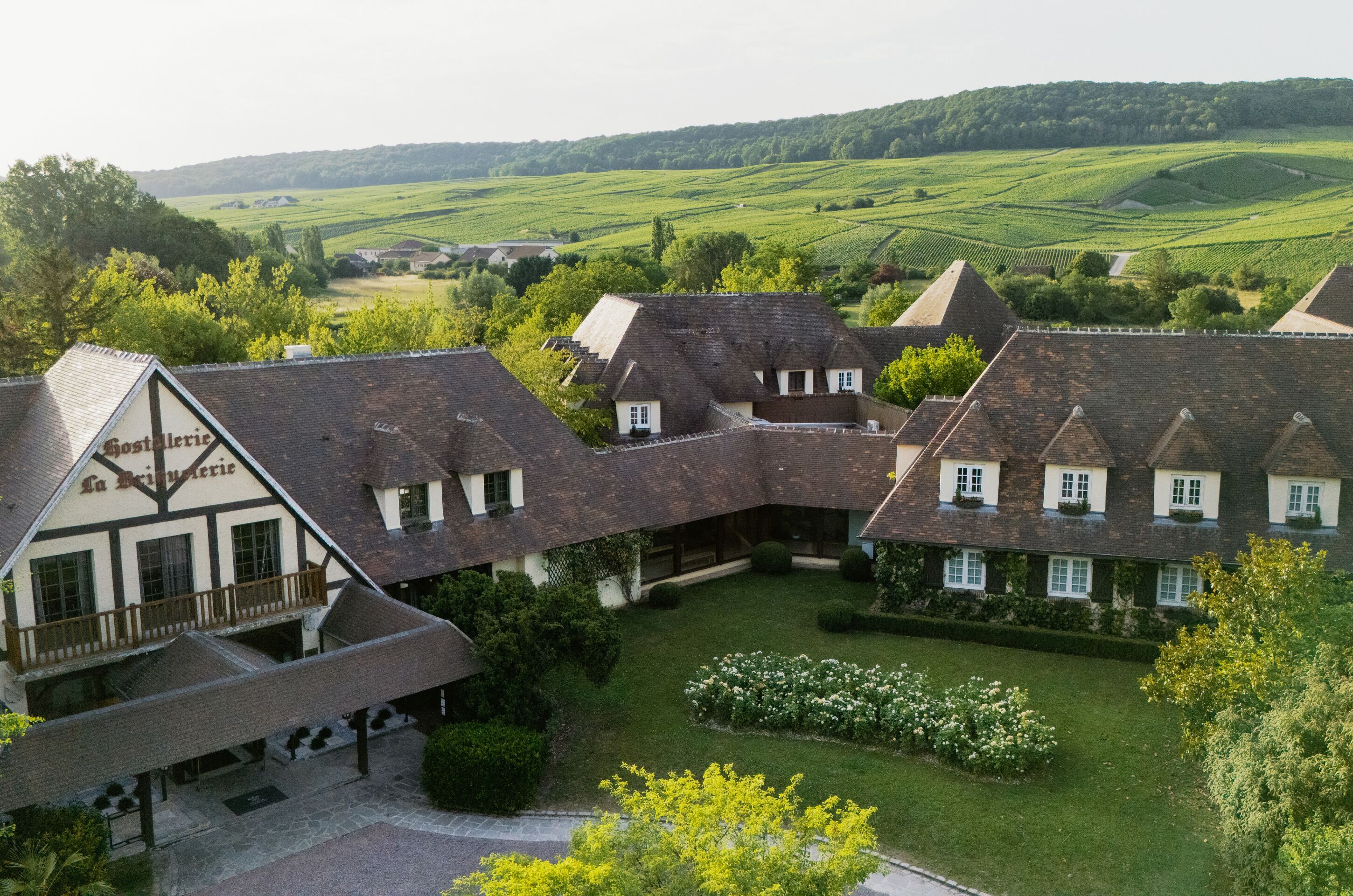 A traditional European-style building with multiple rooms, a courtyard, and a view of the surrounding countryside.