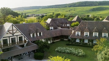 A traditional European-style building with multiple rooms, a courtyard, and a view of the surrounding countryside.