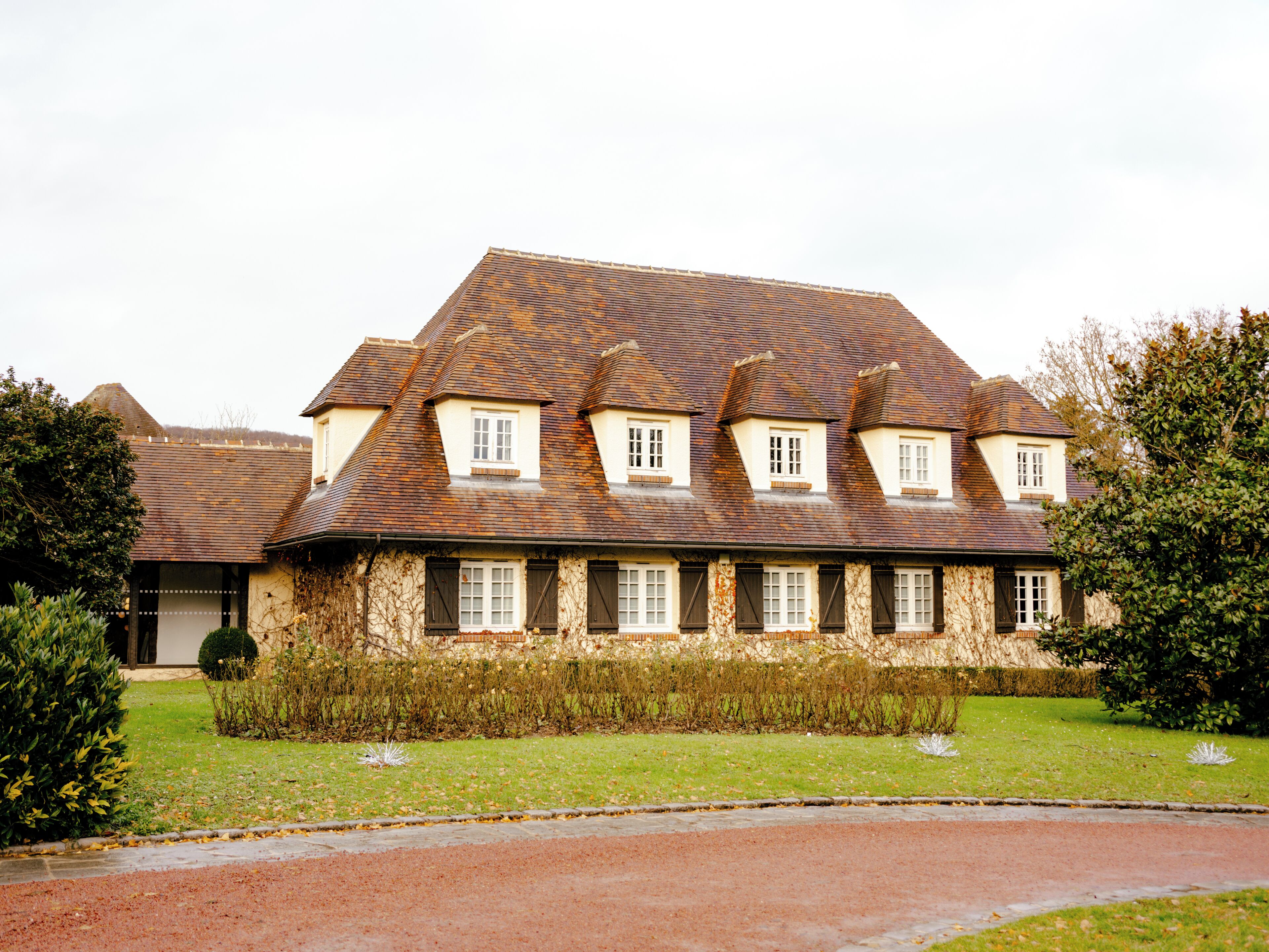 A large, historic building with a symmetrical facade, multiple windows, and a central entrance.