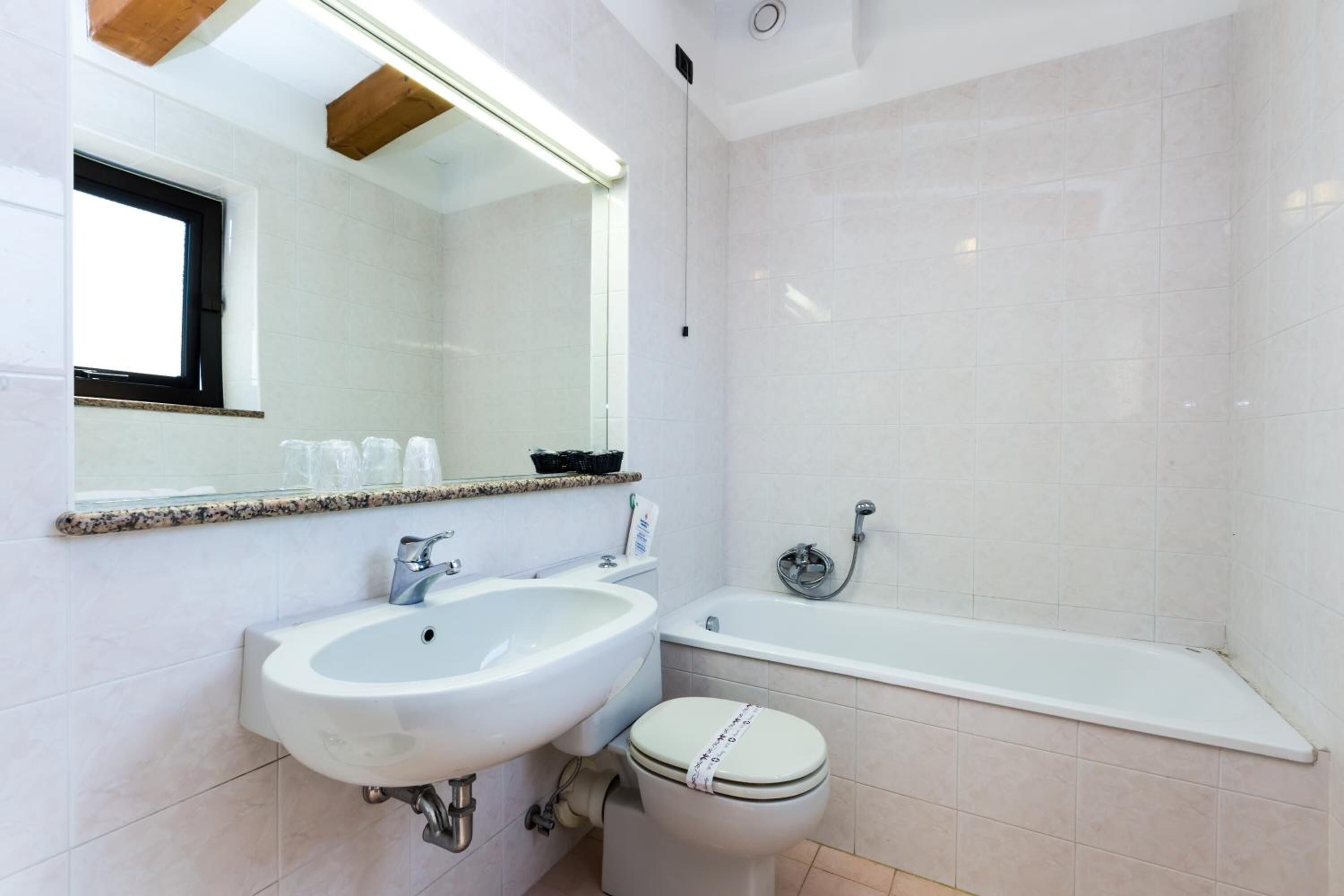 combined shower/bathtub, deep-soaking bathtub, hair dryer, towels