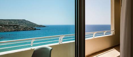 A balcony with a view of the sea and a rocky coastline.