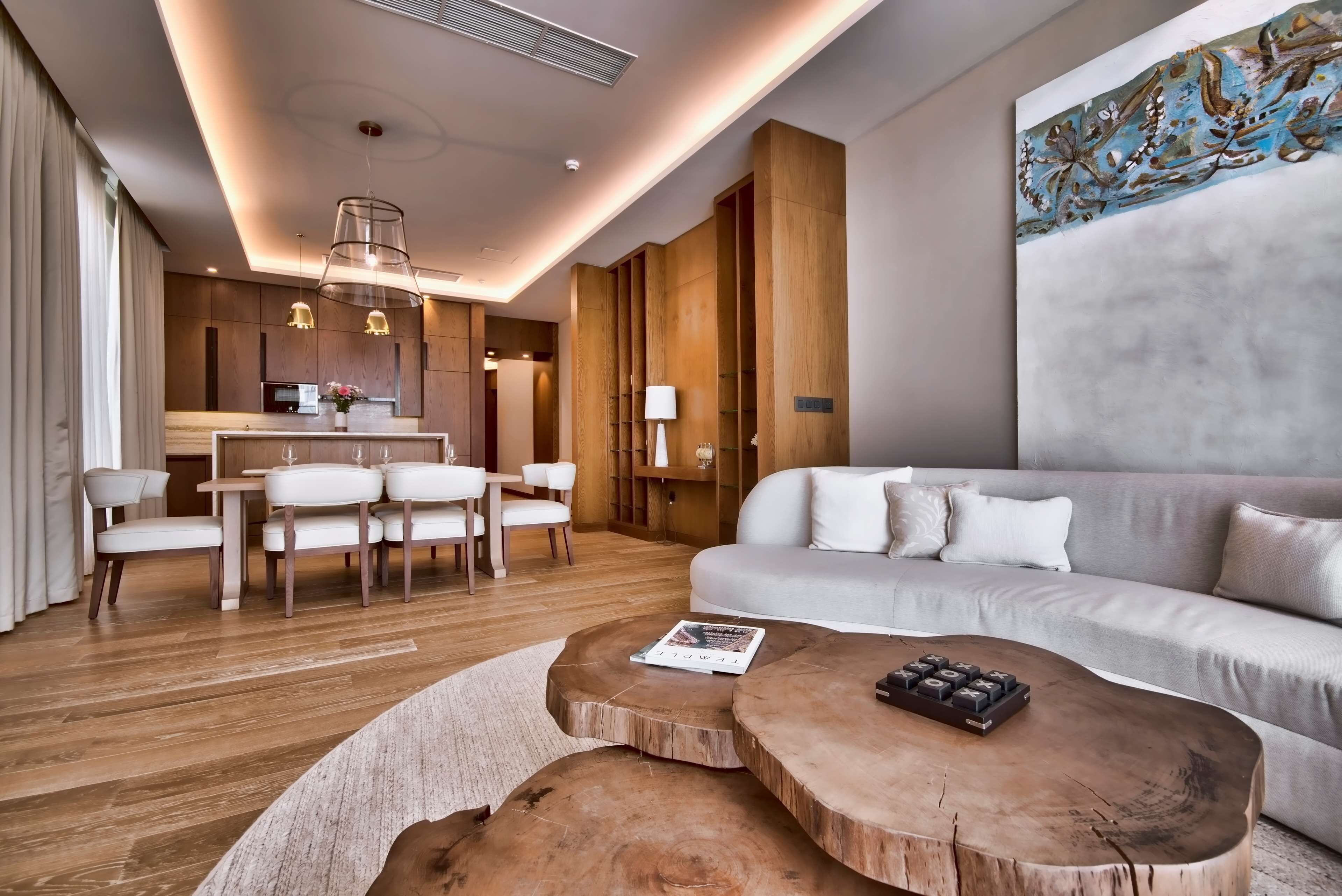 Ein modernes Wohnzimmer mit Sofa, Couchtisch und Essbereich.