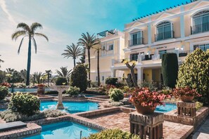 A resort with a swimming pool surrounded by palm trees and well-maintained gardens. - Aloha Gardens by Vacation Care (Marbella)