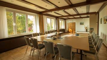 A conference room with a long table and chairs, large windows, and a door labeled "Fasanerie".