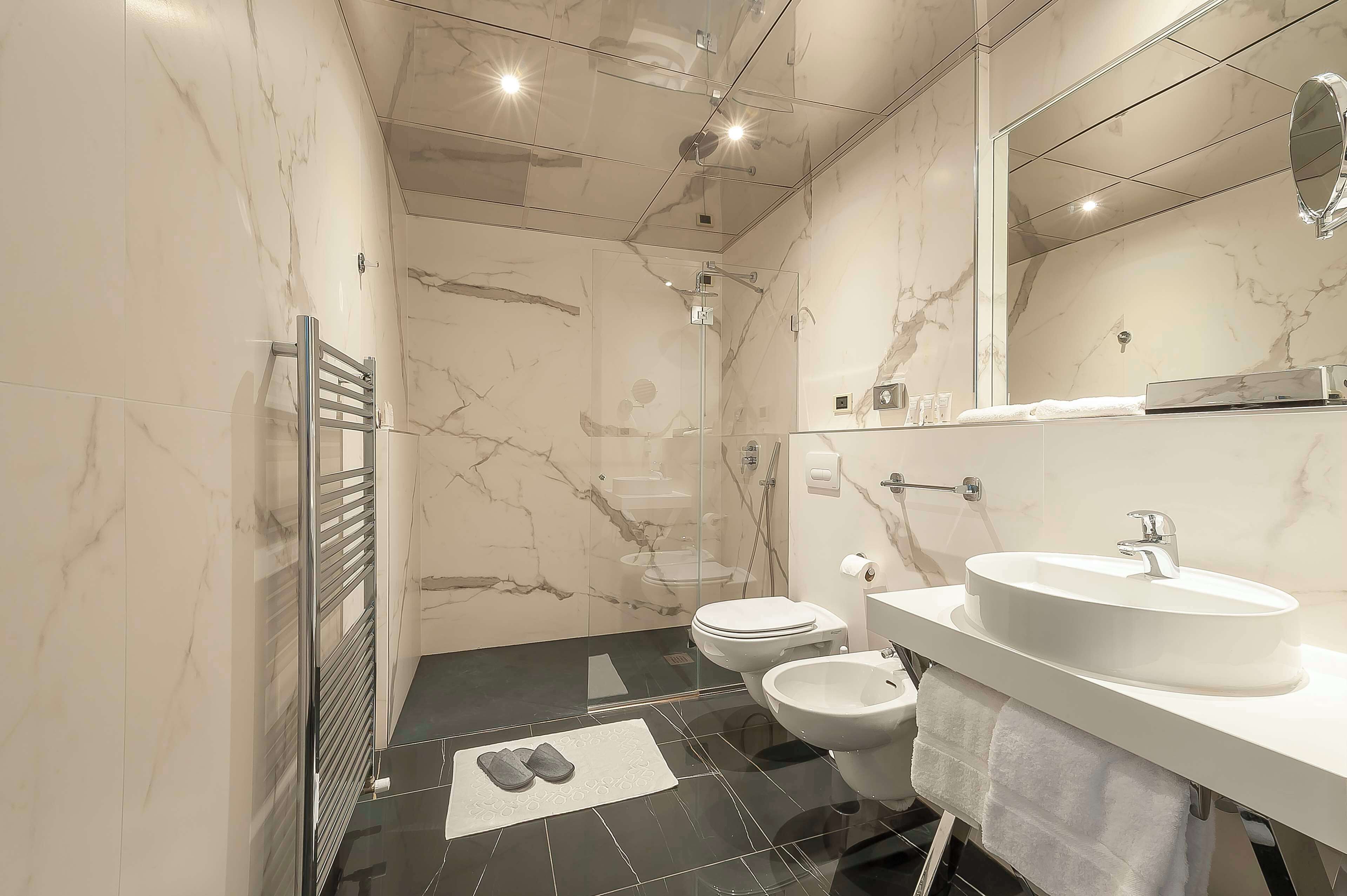 superior quadruple room | bathroom | rainfall showerhead, free toiletries, hair dryer, bidet