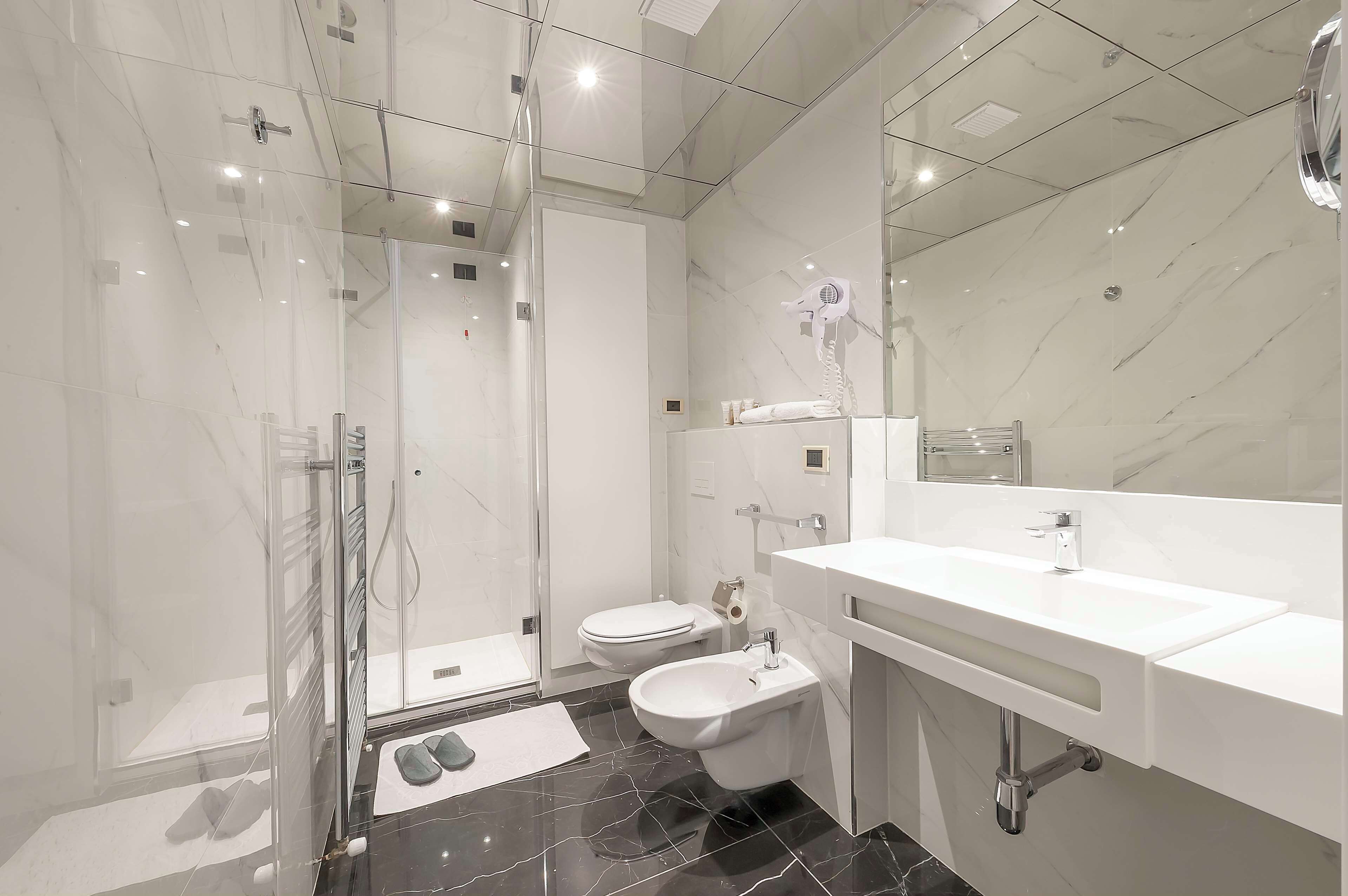 superior triple room | bathroom | rainfall showerhead, free toiletries, hair dryer, bidet