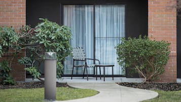 Desk, laptop workspace, blackout drapes, iron/ironing board