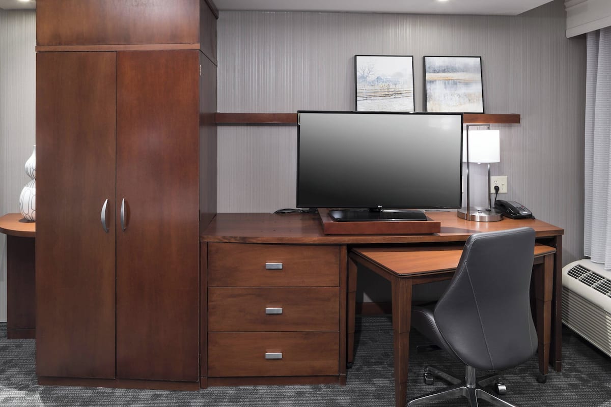 Desk, laptop workspace, blackout drapes, iron/ironing board
