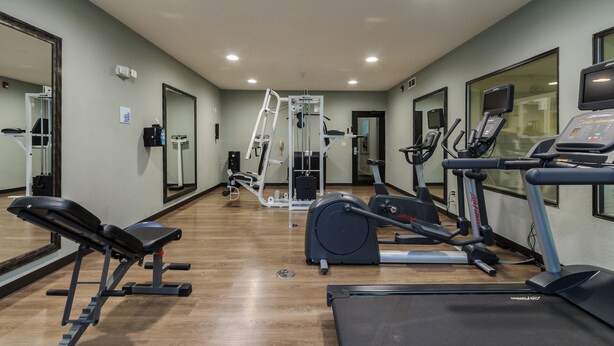 A gym with cardio equipment, weight machines, and a mirrored wall. - Holiday Inn Express Hotel & Suites South Bend by IHG (South Bend)