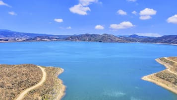 A large body of water with a clear sky and distant mountains.