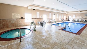 A hotel lobby with a large indoor pool, a reception desk, and a seating area. - Hampton Inn & Suites Effingham (Effingham)