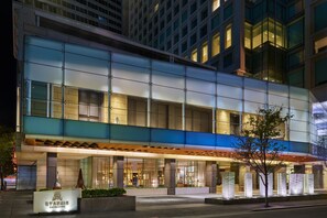 A modern hotel with a glass facade, a covered entrance, and a sign indicating it is a Marriott hotel. - The St. Regis San Francisco (San Francisco)