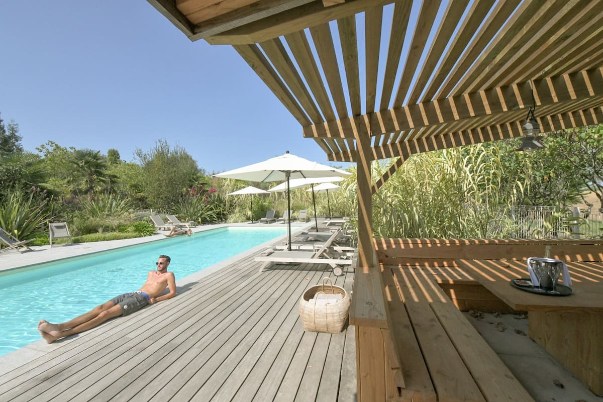 outdoor pool, pool umbrellas, pool loungers