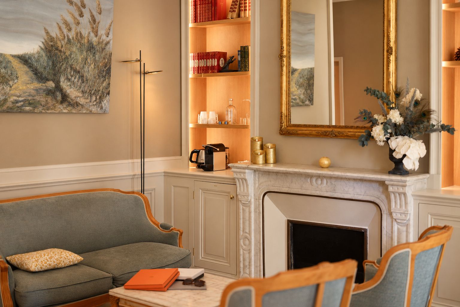 A living room with a fireplace, a sofa, a coffee table, and a bookshelf.