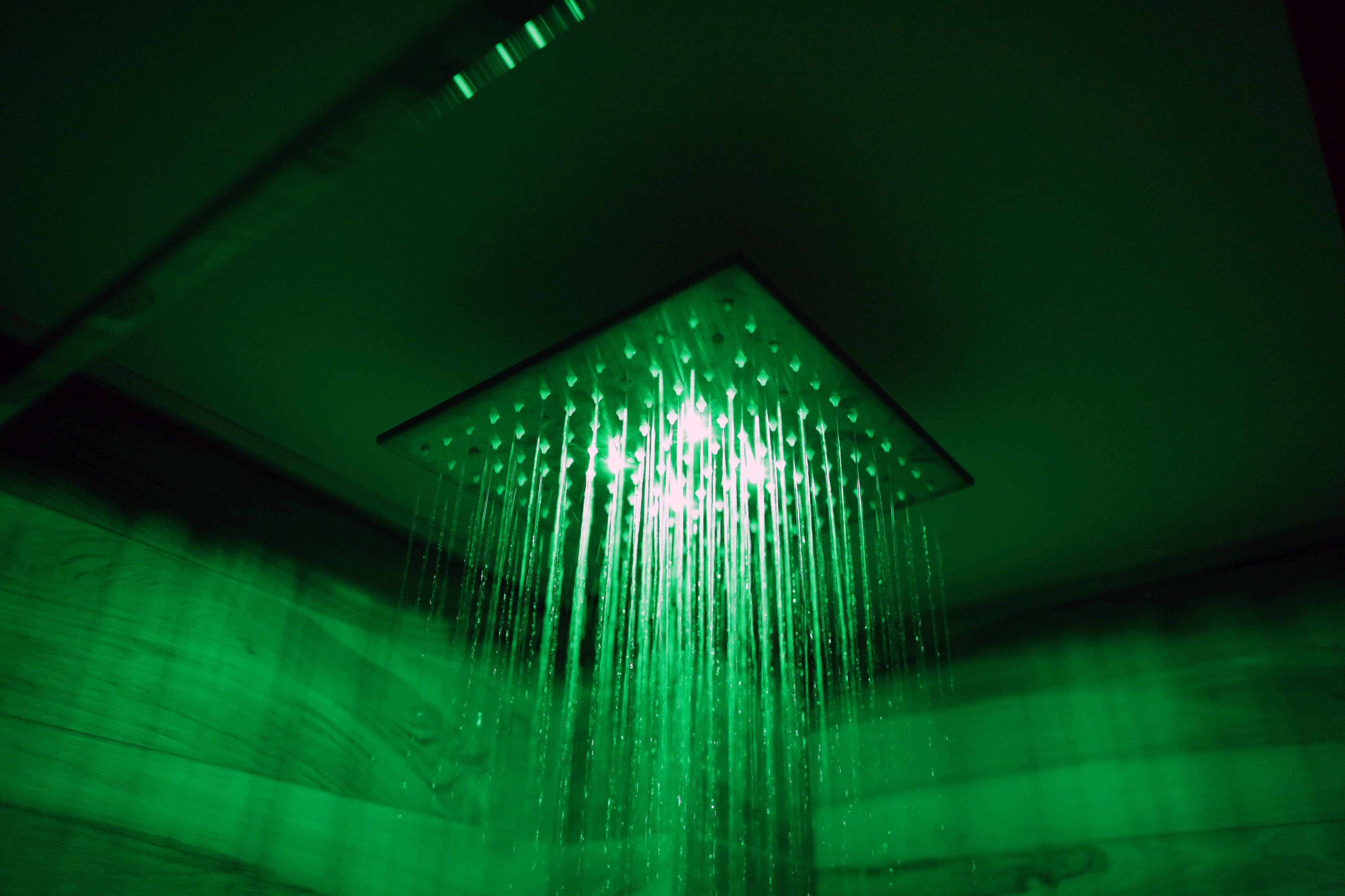 A green-lit square ceiling with a central water feature.