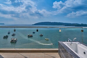 A balcony with a view of the sea, boats, and a distant island. - Le Meridien Kota Kinabalu (Kota Kinabalu)