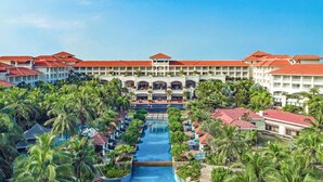 A resort with multiple buildings, a central pool, and palm trees. - Sheraton Haikou Hotel (Haikou)
