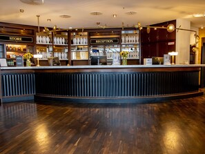 A reception area with a counter, a store, and a reception desk.