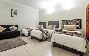 A hotel room with three beds, a sofa, and a small rug. - Oudaya Hotel & Spa (Marrakech)