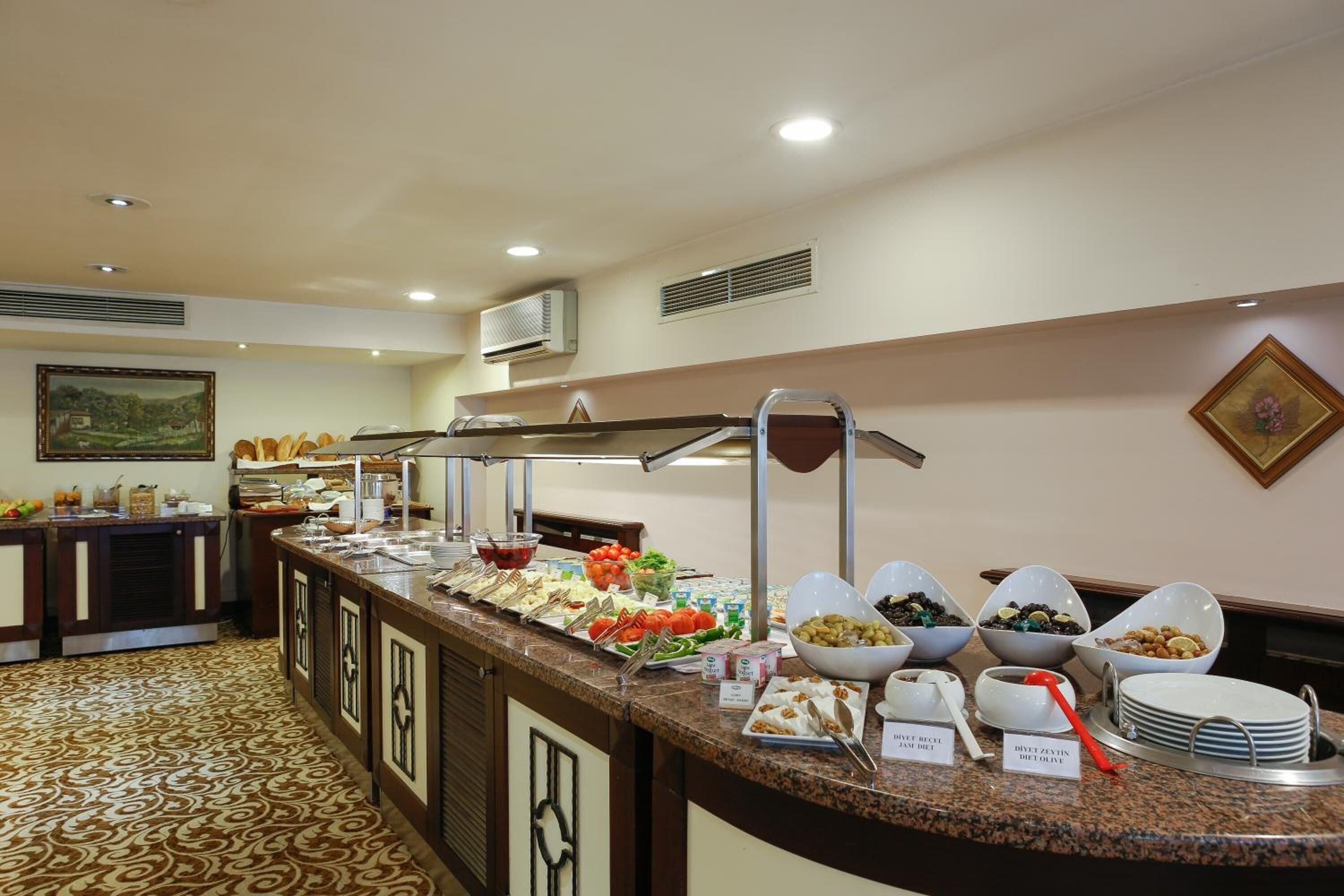 A buffet setup with various food items and serving utensils.
